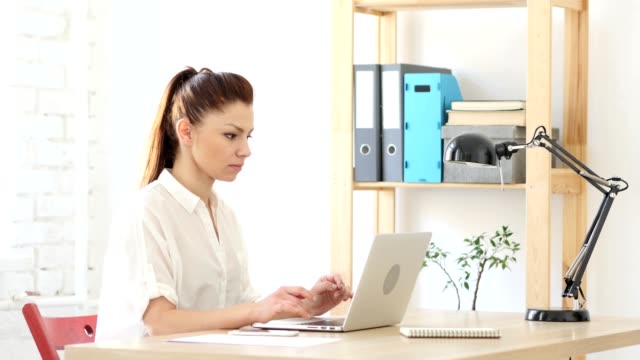 Woman--Upset-by-Loss,-Working-on-Laptop