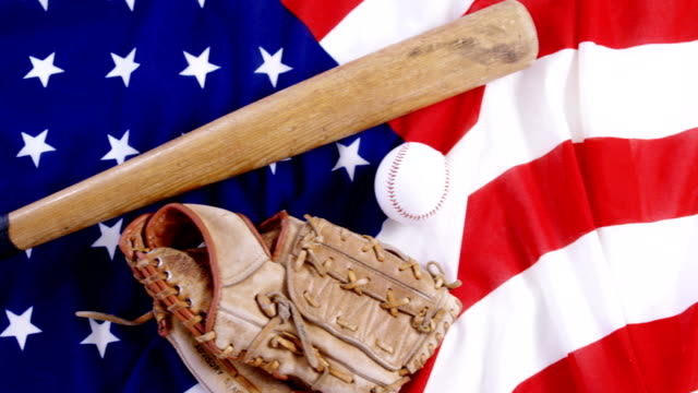 Baseball,-baseball-bat-and--baseball-gloves-on-an-American-flag