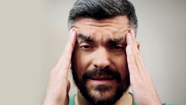 Mann-Gefühl-starke-Kopfschmerzen-verursacht-durch-die-Migräne,-close-up-Gesicht-mit-emotion