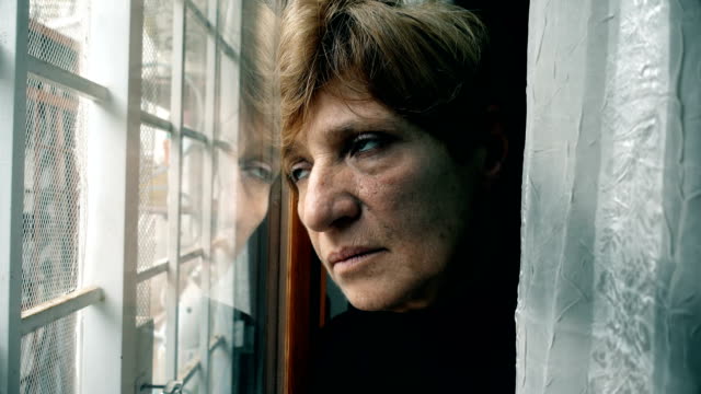 depressed,thoughtful-mature-woman-at-the-window