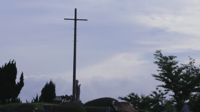 The-cross-and-statue-of-the-Virgin-Mary-at-Cemetery-in-asia