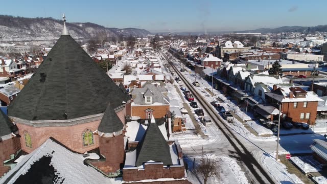 Slow-Dolly-Around-Church-Steeple-in-Small-Rust-Belt-Town-in-Winter