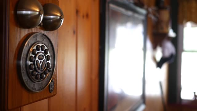 Camera-pans-to-antique-old-landline-telephone-in-country-home