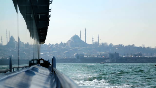 View-of-Sultan-Ahmed-Mosque-from-tourist-cruiser,-reflection-of-scenery-on-boat
