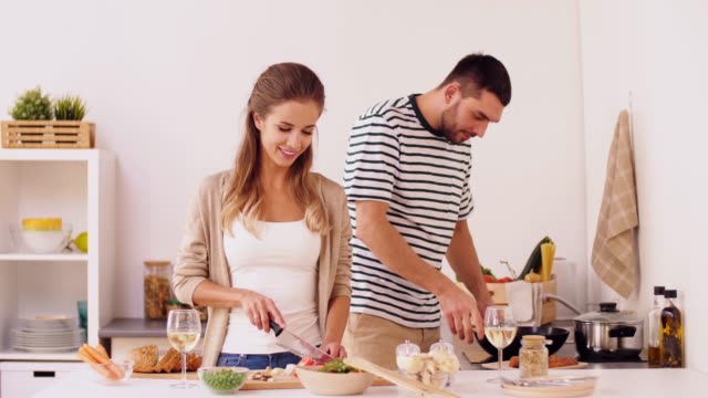 happy-couple-cooking-and-serving-food-at-home