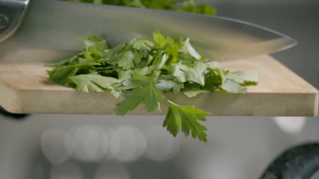 Falling-of-parsley-into-the-frying-pan.-Slow-motion-240-fps