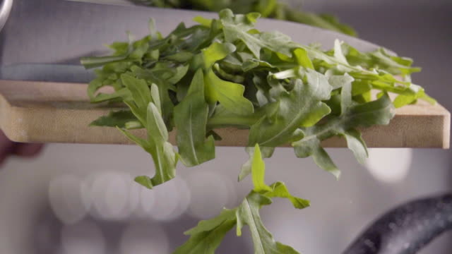 Falling-of-arugula-into-the-frying-pan.-Slow-motion-240-fps