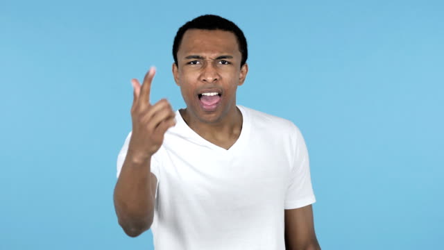 Fighting-Young-African-Man-in-Anger-Isolated-on-Blue-Background
