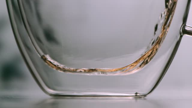 Tea-poured-into-a-glass-in-soft-slowmotion
