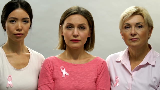 Portrait-of-sad-women-with-pink-ribbons,-breast-cancer-prevention,-bad-statistic