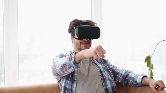 Man-driving-in-virtual-reality-wearing-vr-headset
