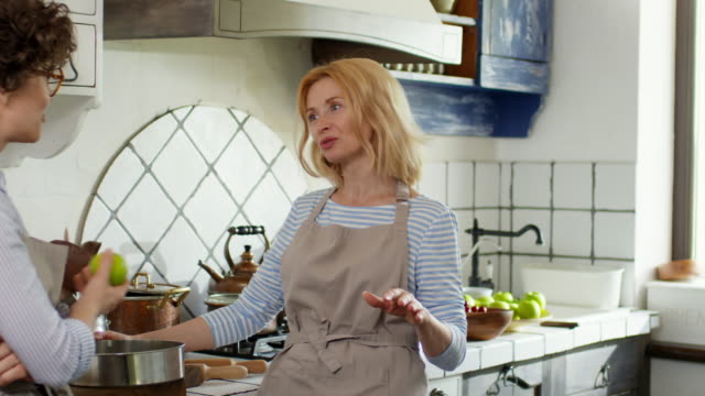 Two-Women-Talking-in-Kitchen