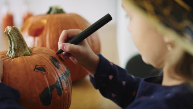 Girl-making-decorations-for-Halloween