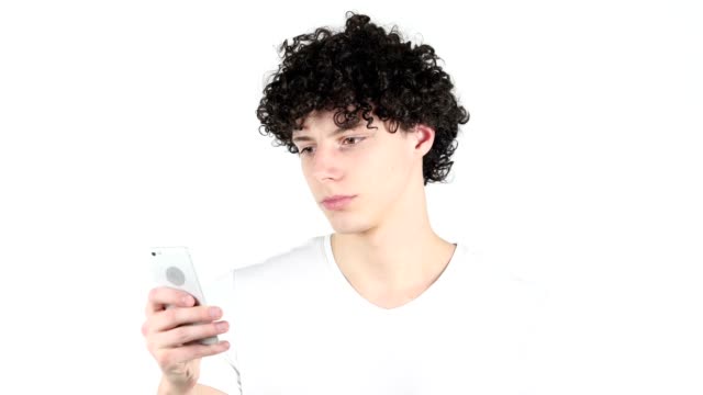Using-Smartphone,-Texting-Young-Man-with-Curly-Hairs