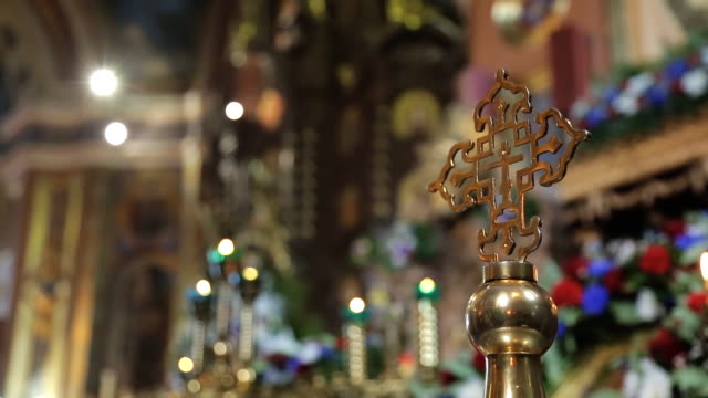 Golden-orthodox-cross-on-background-of-rich-decoration-of-church