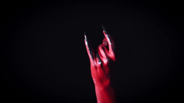 4k-Horror-Halloween-Devil's-Hand-Showing-Rock