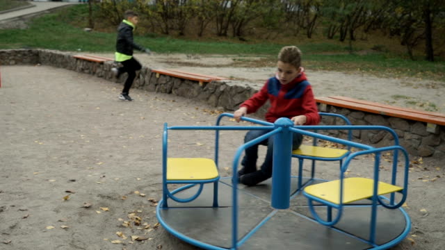Little-boy-spinning-on-a-swing-at-playground