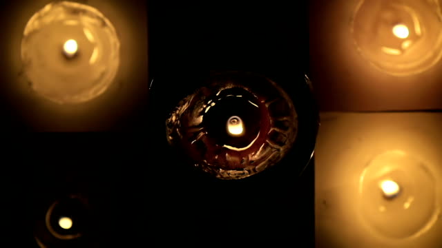 Abstract-a-lot-of-beautiful-wax-candles-burning-view-from-the-top-in-slow-motion.