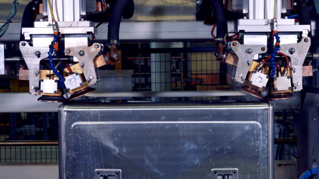 A-steel-box-turns-inside-a-robotic-machine-during-welding-process.-4K.