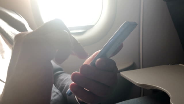 Man-using-smartphone-in-the-airplane.