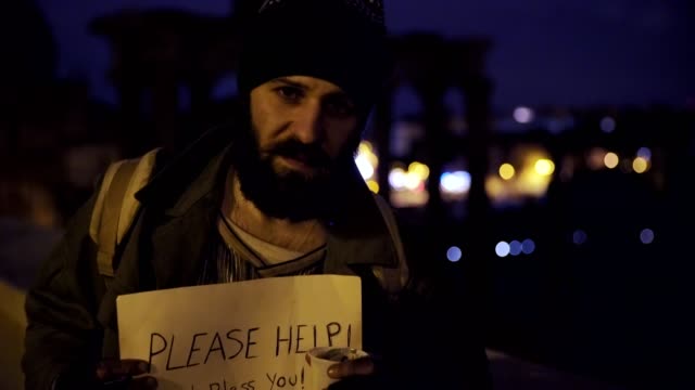 sad-and-desperate-lonely-beggar-in-the-street-by-night--asks-alms