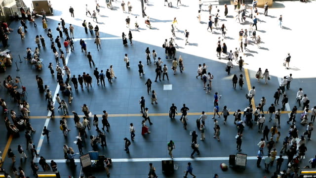 Anonymous-crowd-of-people-walking-on-walk-way-in-rush-hour-on-Osaka-station,Japan.-Slow-motion-footage