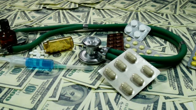 Panning-Shot-Of-Dollar-Bills-And-Medicine-On-The-Table