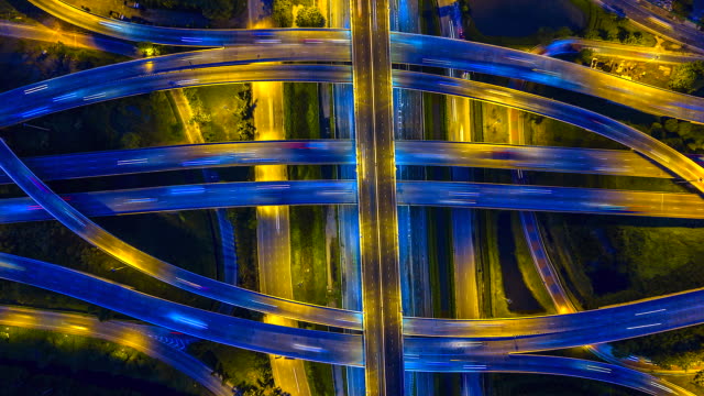 Aerial-view-Time-lapse-of-the-expressway,-motorway-and-highway-in-the-detail-of-intersection-at-night