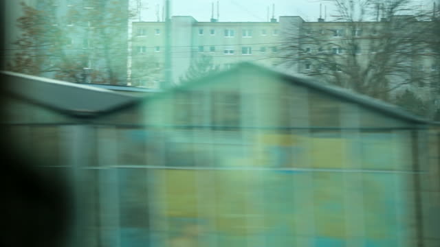 Urban-city-landscape-seen-from-a-moving-train-in-motion