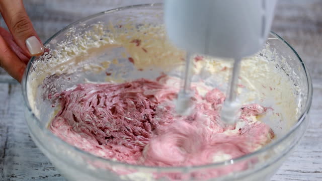 Mixing-cream-of-vanilla-and-berry-fruits.
