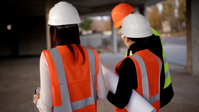 The-engineer-and-two-women-inspector-conduct-an-inspection-and-bypass-the-construction-site.