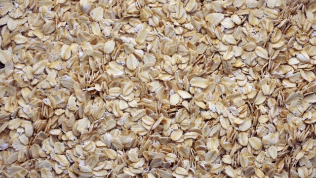 Slow-motion-closeup-oat-flakes-falling-into-bowl