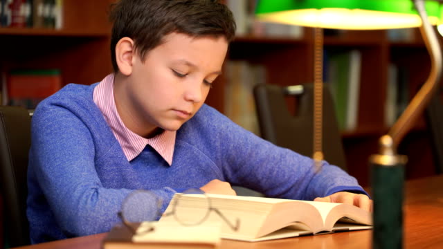 portrait-of-schoolboy-doing-their-homework-and-sleeping-on-the-book