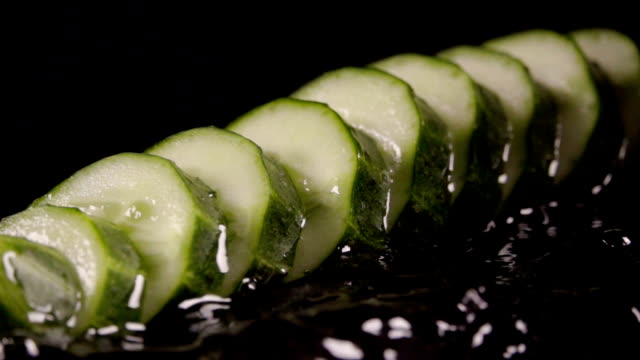 Falling-of-sliced-cucumber-into-the-wet-table.-Slow-motion-240-fps