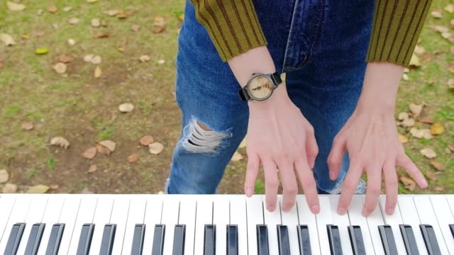 Playful-Woman-playing-Piano-in-Outdoor-Park-in-Autumn-Season