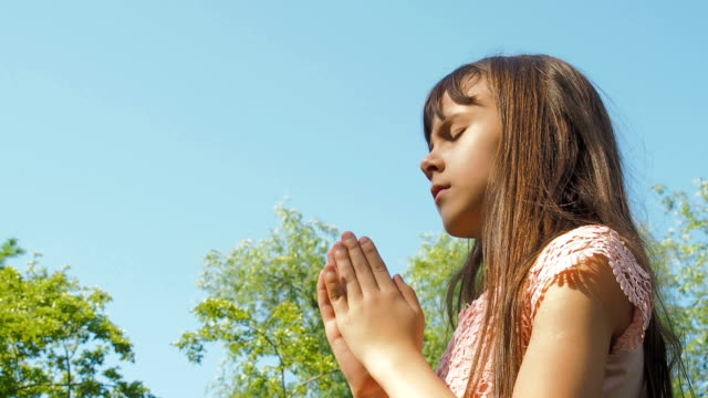 The-child-prays-in-nature.