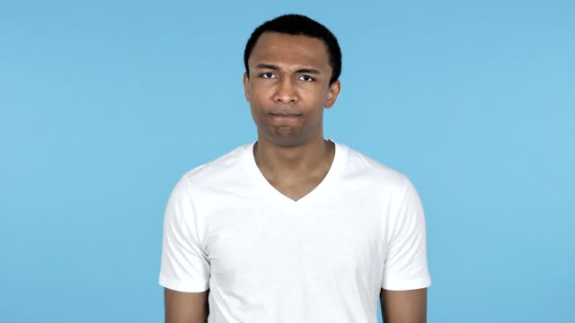 African-Man-Shaking-Head-to-Reject-Isolated-on-Blue-Background