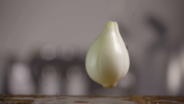 Falling-of-white-onion-into-the-wet-table.-Slow-motion-480-fps