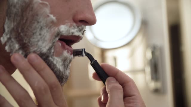 Men-Face-Hair-Care.-Male-Shaving-Beard-With-Razor-Closeup