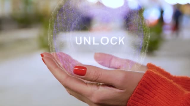 Female-hands-holding-hologram-with-text-Unlock