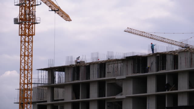 Builders-on-the-Edge-of-a-Skyscraper-Under-Construction.-Workers-at-a-Construction-Site