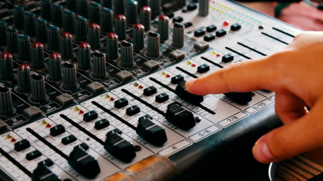 DJ-console-or-mixer,-the-hand-presses-the-levers-and-buttons-of-remote