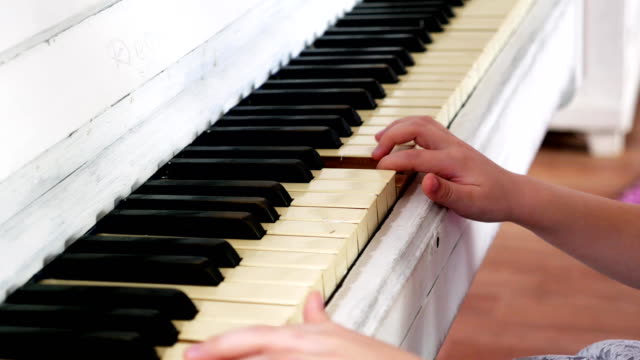 Beautiful-hands-of-girl-playing-white-piano-4k.