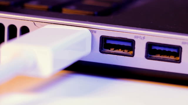 Closeup-of-HDMI-cable-plug-inserted-into-port-on-the-side-of-a-laptop