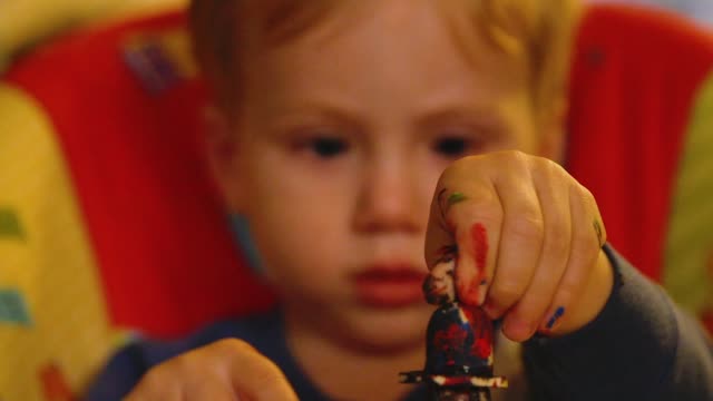 Video-Of-A-Young-Toddler-Boy-Making-A-Christmas-Wooden-Toy-Soldier-Craft-With-His-Mom-At-Their-Living-Room-Table
