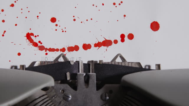 Typewriter-spelling-horror-movie-night-on-paper-with-blood-splashes