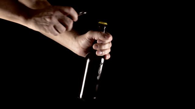 bottle-opening-with-an-opener-on-a-black-background