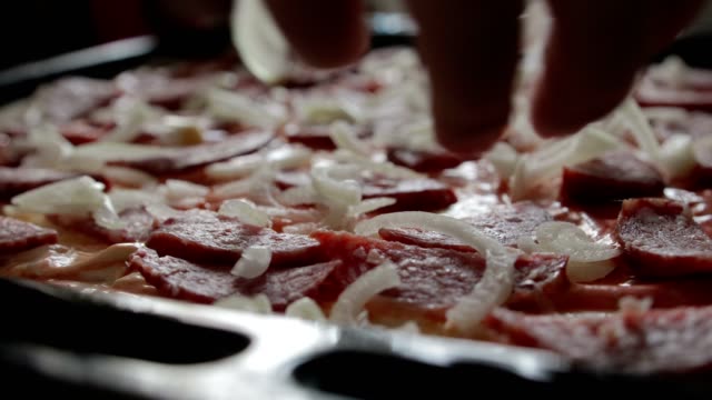 Bow-falls-on-top-of-the-pizza,-salami.-The-concept-of-pizza