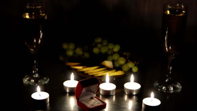 Romantic-evening-with-candles-with-champagne-and-fruits.-An-offer-of-marriage
