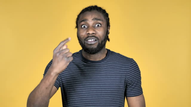 Fighting-Angry-Casual-African-Man-Isolated-on-Yellow-Background
